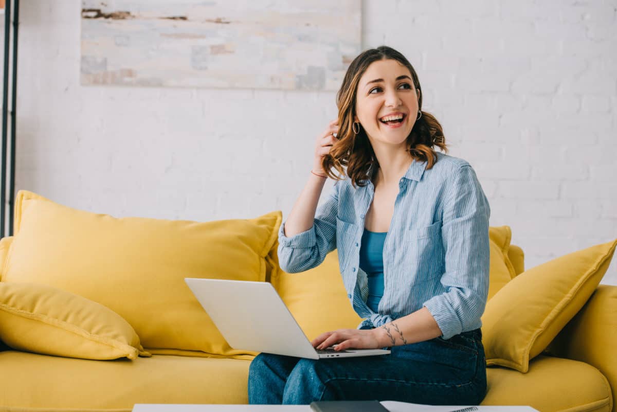 pretty woman sitting on yellow sofa